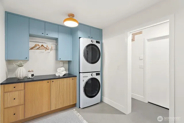 a utility room with sink dryer and washer