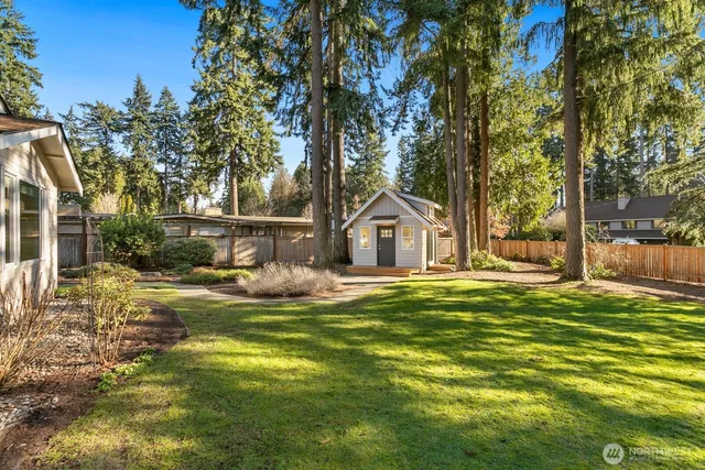 a view of a house with pool and sitting area