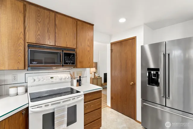 a kitchen with a refrigerator stove and microwave