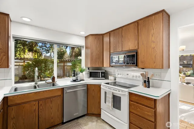a kitchen with a sink stove and microwave