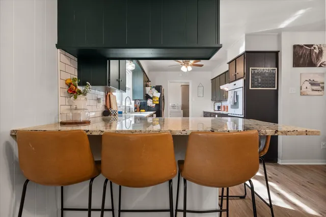 a dining room with furniture and wooden floor