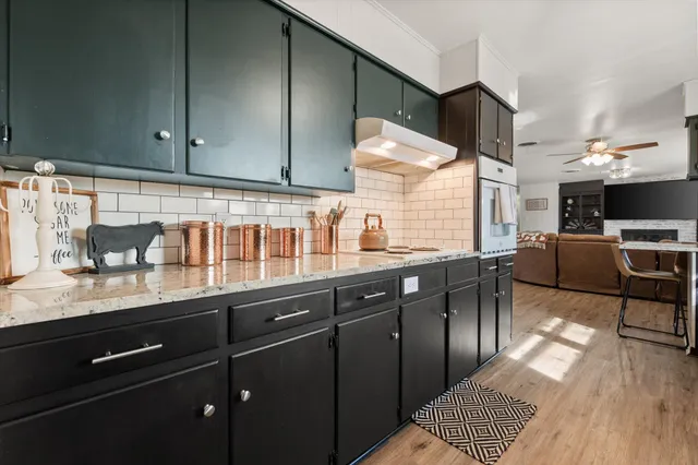 a kitchen with stainless steel appliances granite countertop a sink dishwasher stove and cabinets