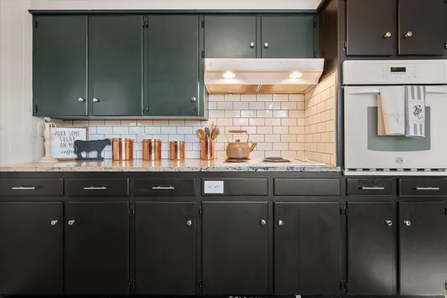 a bathroom with a sink vanity granite and a mirror