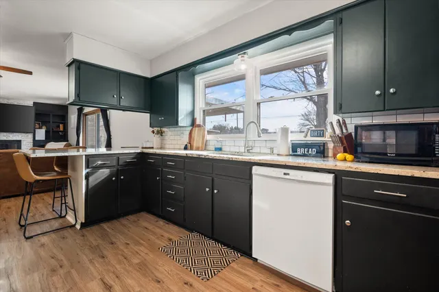 a kitchen with a sink stove and cabinets