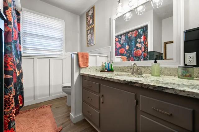 a bathroom with a sink a vanity and a mirror