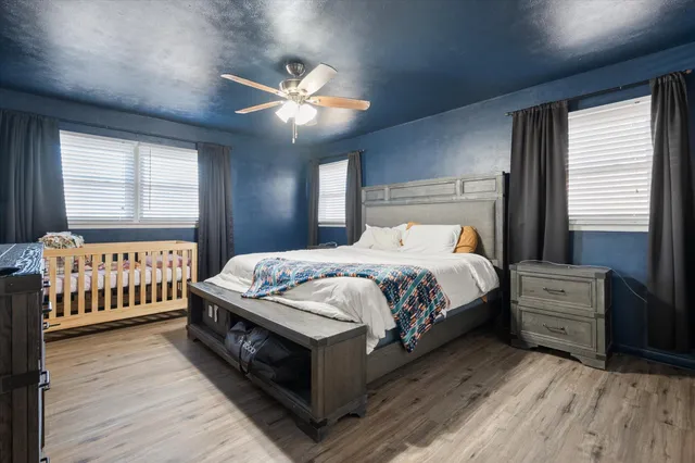 a bedroom with a large bed and a chandelier