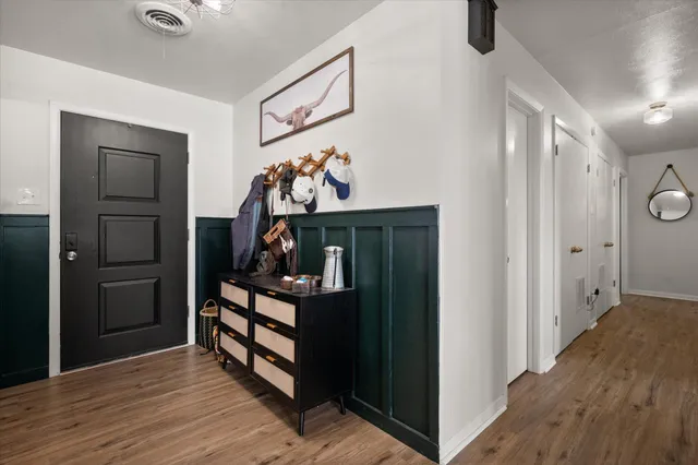 a view of an entryway with wooden floor