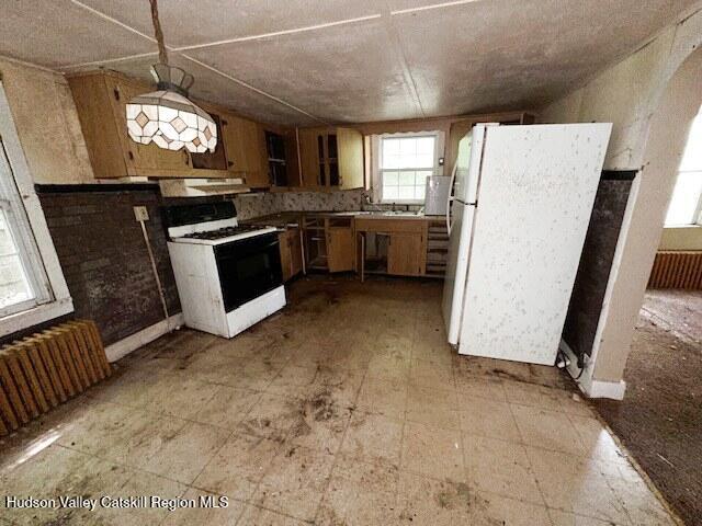 818 Cauterskill Road Catskill, NY 12414 - Photo 3 of 17 a kitchen with a stove a refrigerator and a sink