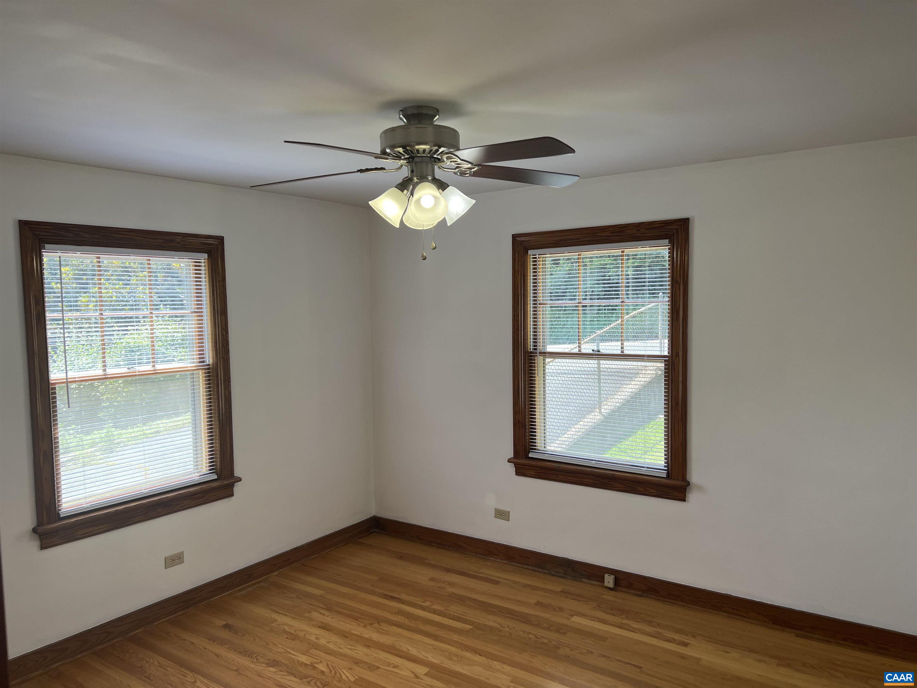 1320 Avon Street Charlottesville, VA 22902 - Photo 21 of 40 an empty room with wooden floor chandelier fan and windows