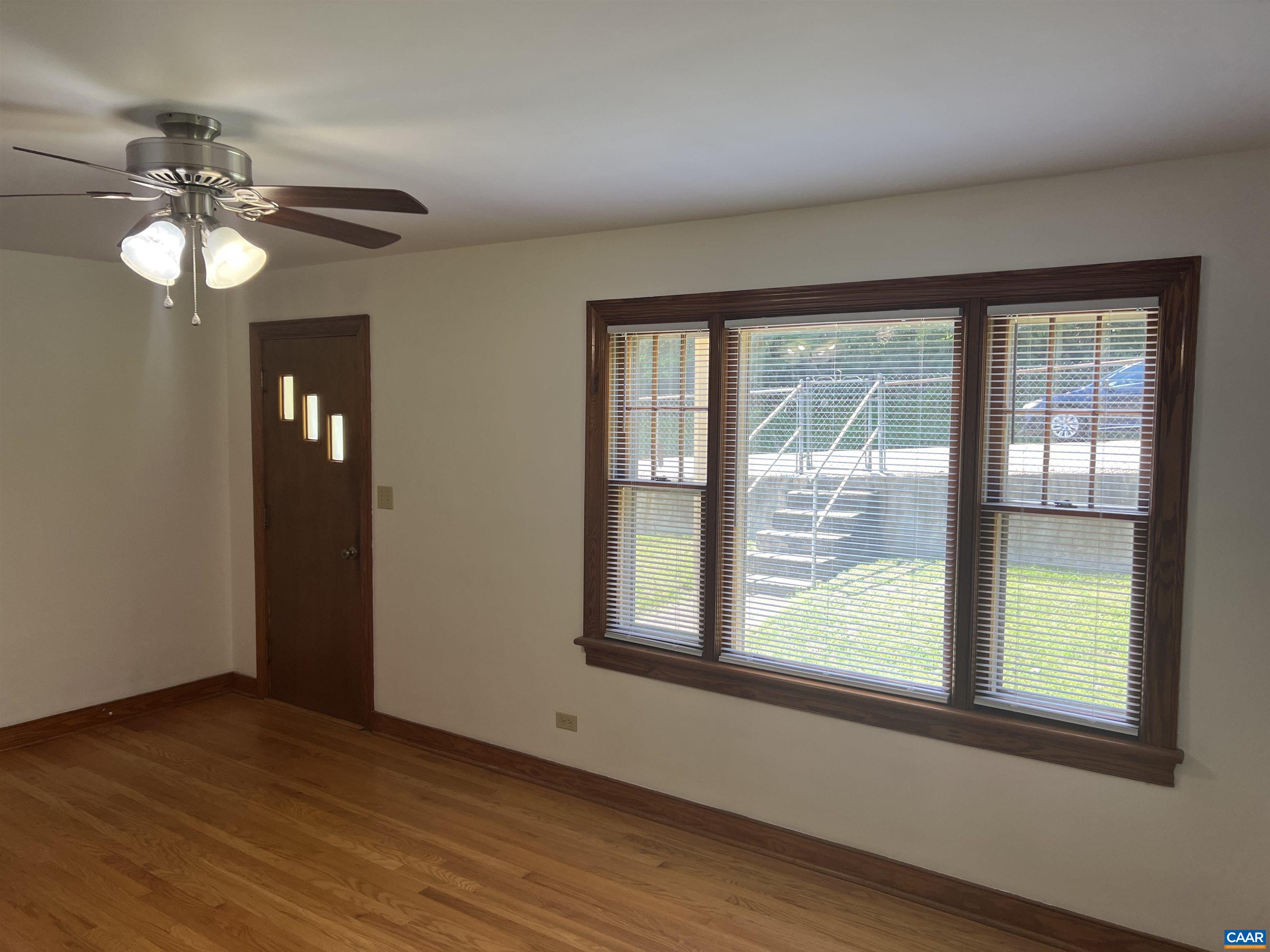 1320 Avon Street Charlottesville, VA 22902 - Photo 4 of 40 a view of an empty room with wooden floor and a window