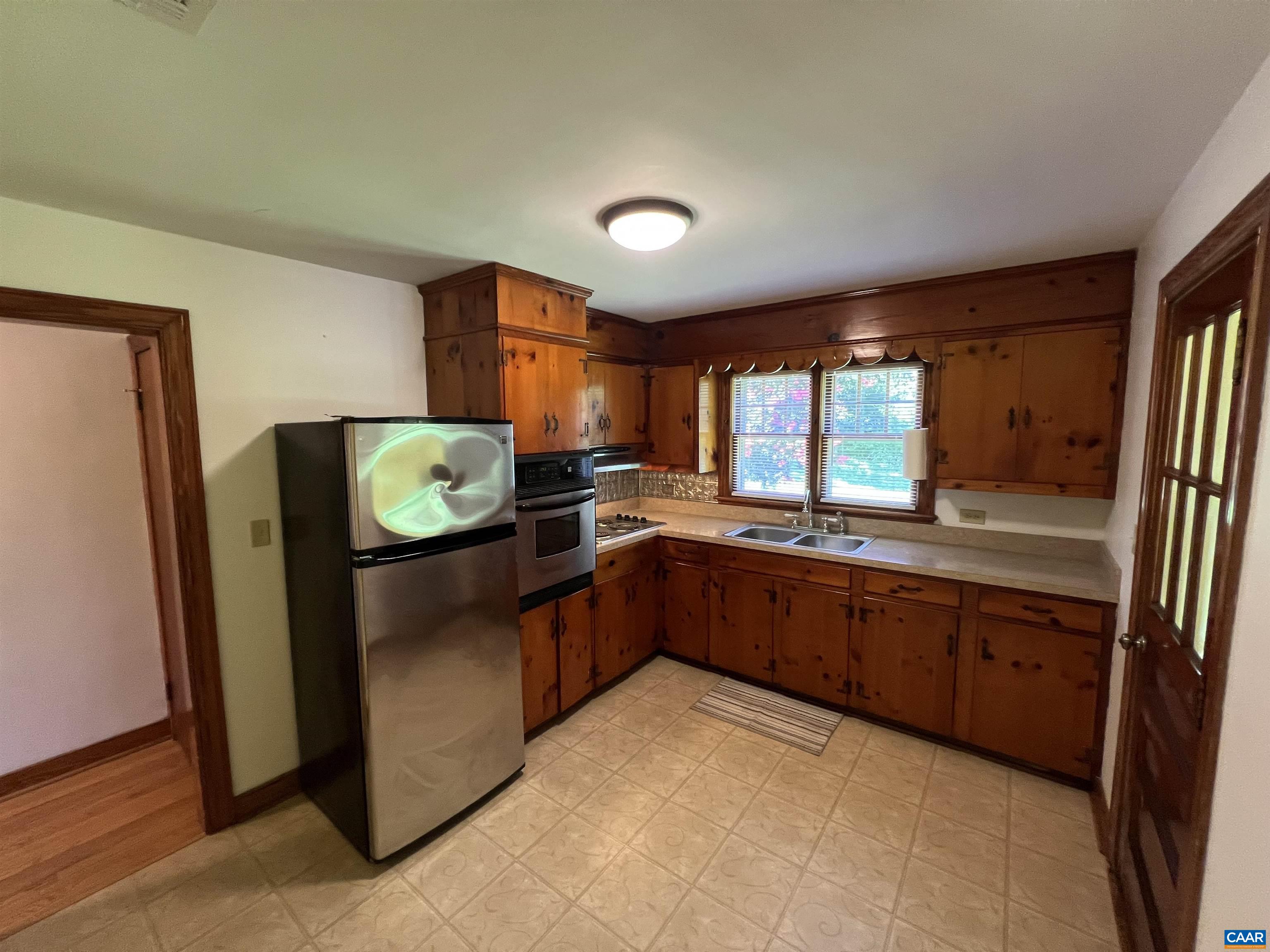 1320 Avon Street Charlottesville, VA 22902 - Photo 7 of 40 a kitchen with stainless steel appliances granite countertop a refrigerator and a sink