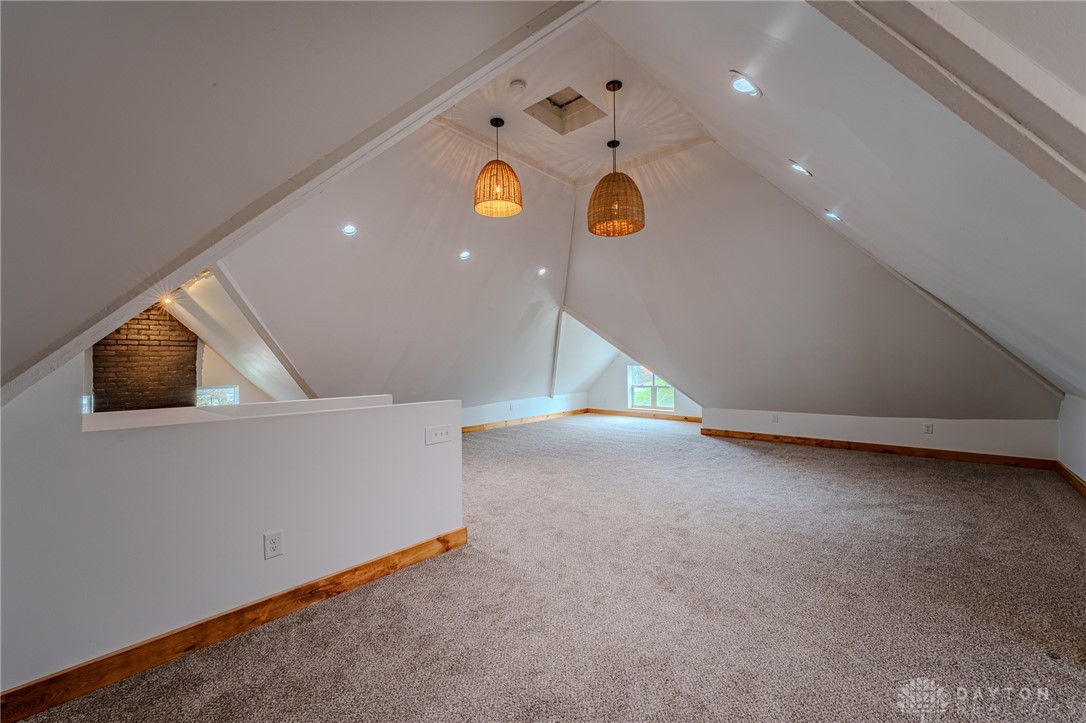 308 Yankee Road Middletown, OH 45044 - Photo 38 of 47 This spacious attic space features ample natural light and plush carpeting, offering versatile living options.