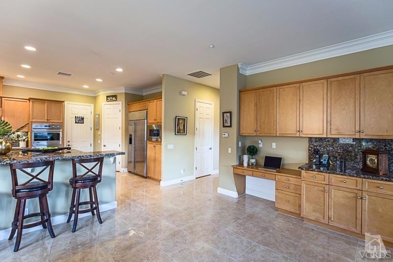 12366 Nelson Road Moorpark, CA 93021 - Photo 18 of 67 a kitchen with stainless steel appliances granite countertop a stove a sink a refrigerator with a dining table and chairs