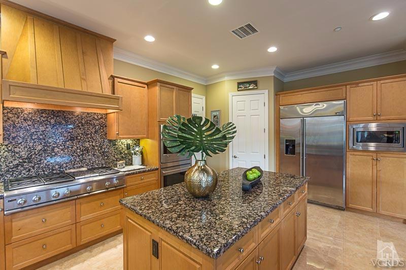 12366 Nelson Road Moorpark, CA 93021 - Photo 22 of 67 a kitchen with stainless steel appliances granite countertop a sink a refrigerator and a counter space