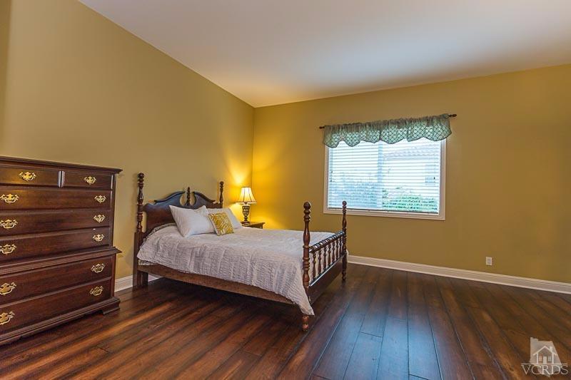 12366 Nelson Road Moorpark, CA 93021 - Photo 29 of 67 a bedroom with a bed and wooden floor
