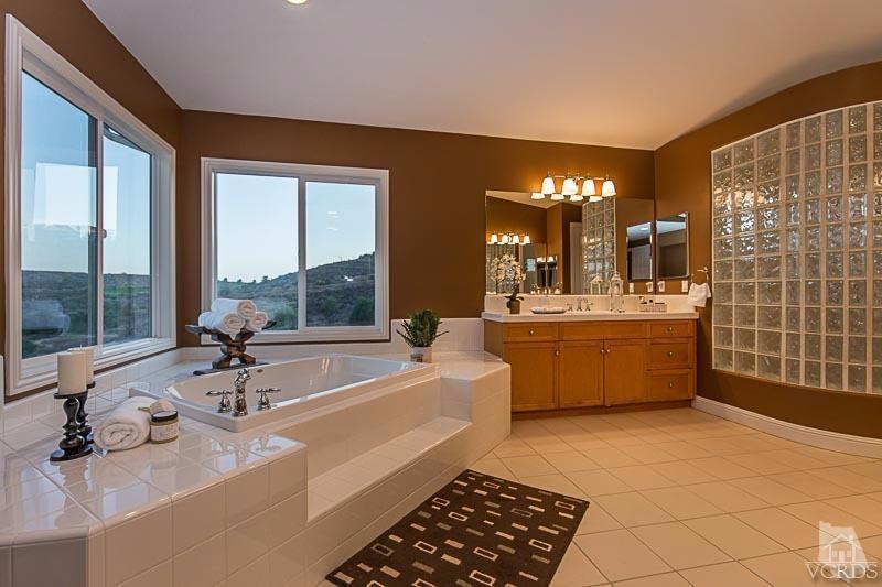 12366 Nelson Road Moorpark, CA 93021 - Photo 36 of 67 a bathroom with a double vanity sink a mirror and a bathtub