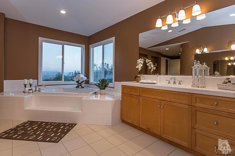 12366 Nelson Road Moorpark, CA 93021 - Photo 37 of 67 a spacious bathroom with a sink a large mirror and a bathtub