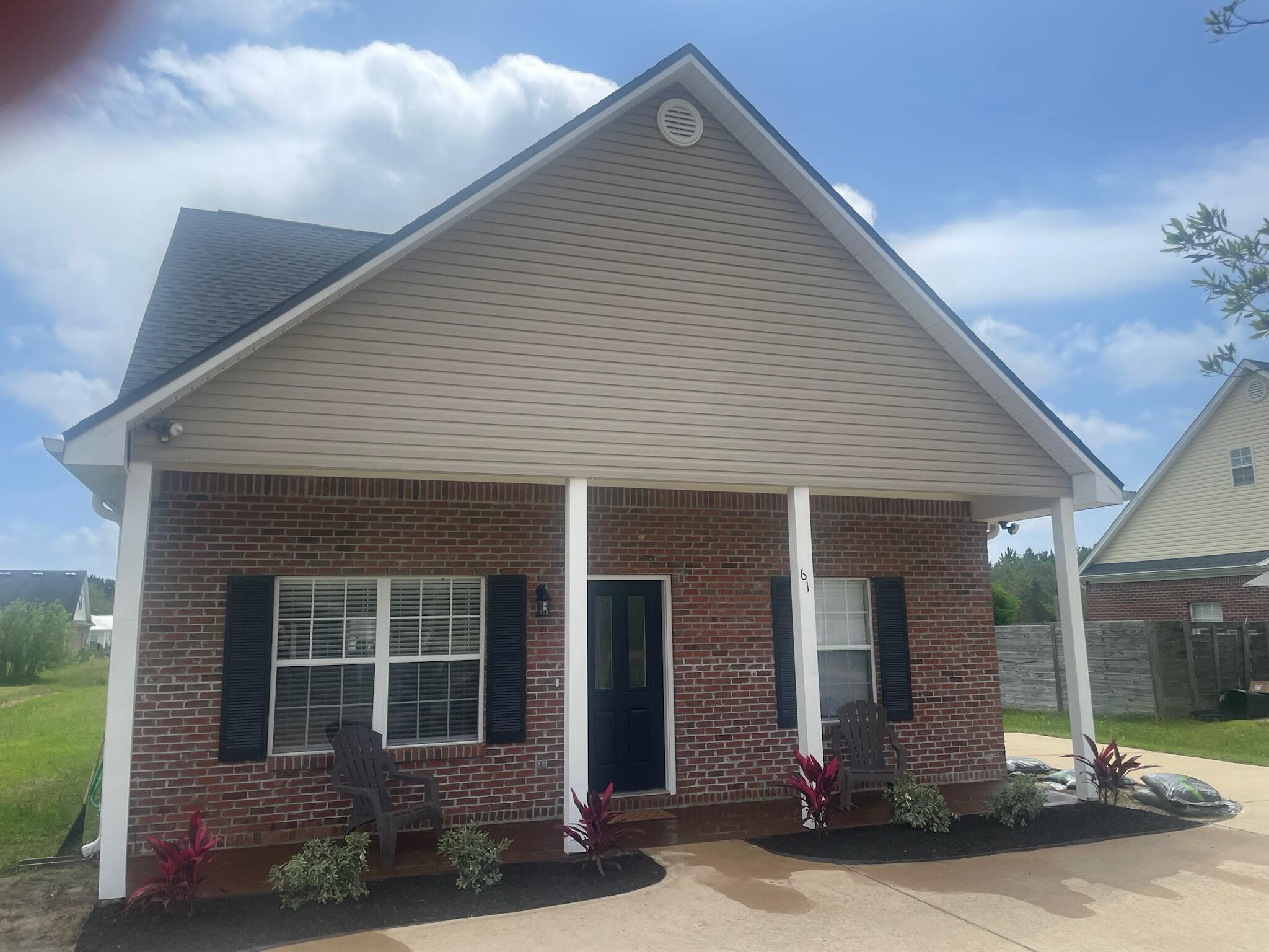 a front view of a house with garden