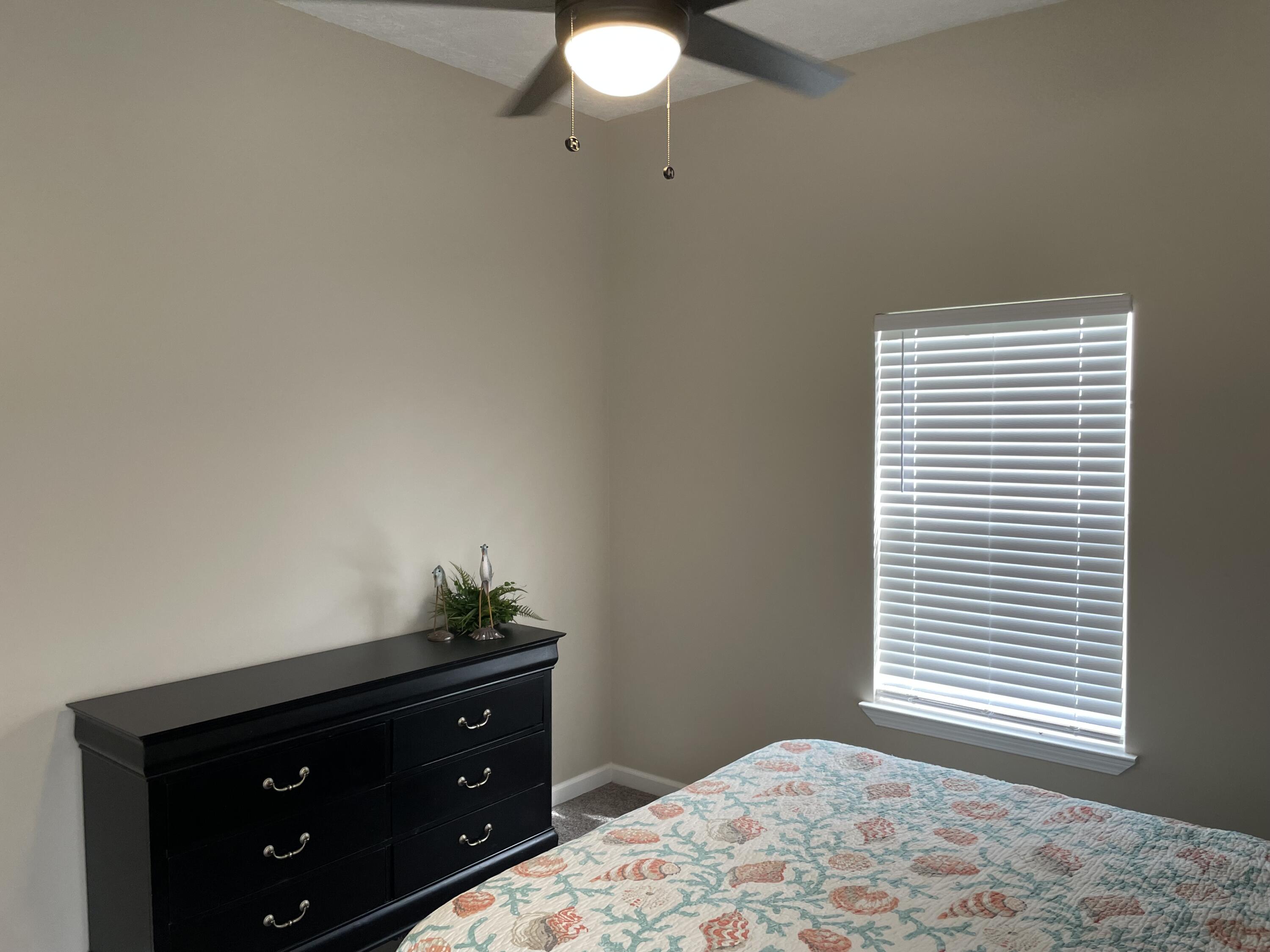 61 Mallot Beach Drive Freeport, FL 32439 - Photo 11 of 19 a bedroom with a bed and a window