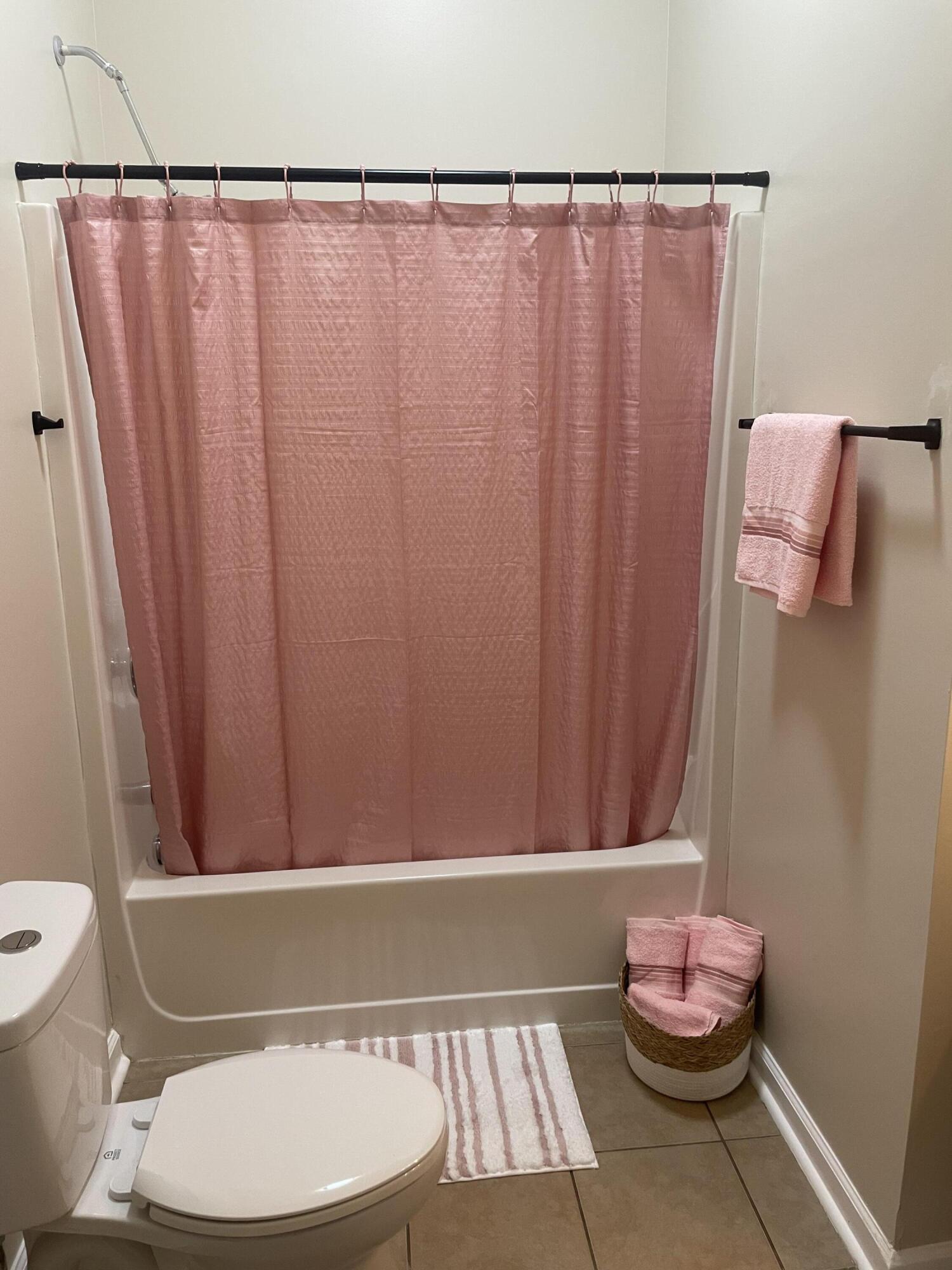61 Mallot Beach Drive Freeport, FL 32439 - Photo 18 of 19 a bathroom with a toilet and a shower curtain