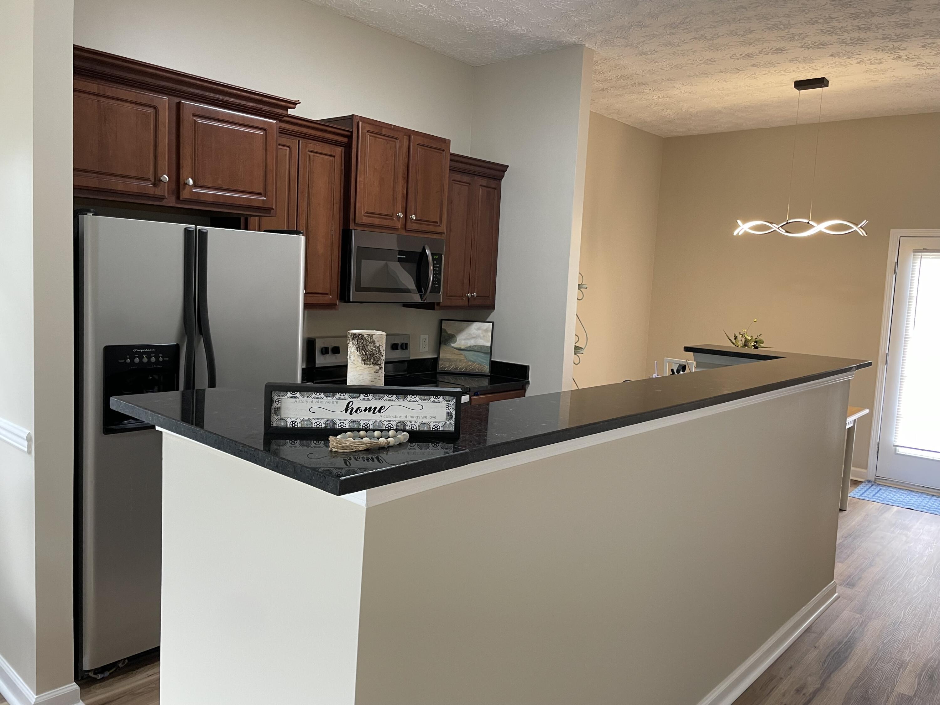 61 Mallot Beach Drive Freeport, FL 32439 - Photo 7 of 19 a kitchen with stainless steel appliances granite countertop a refrigerator and a sink