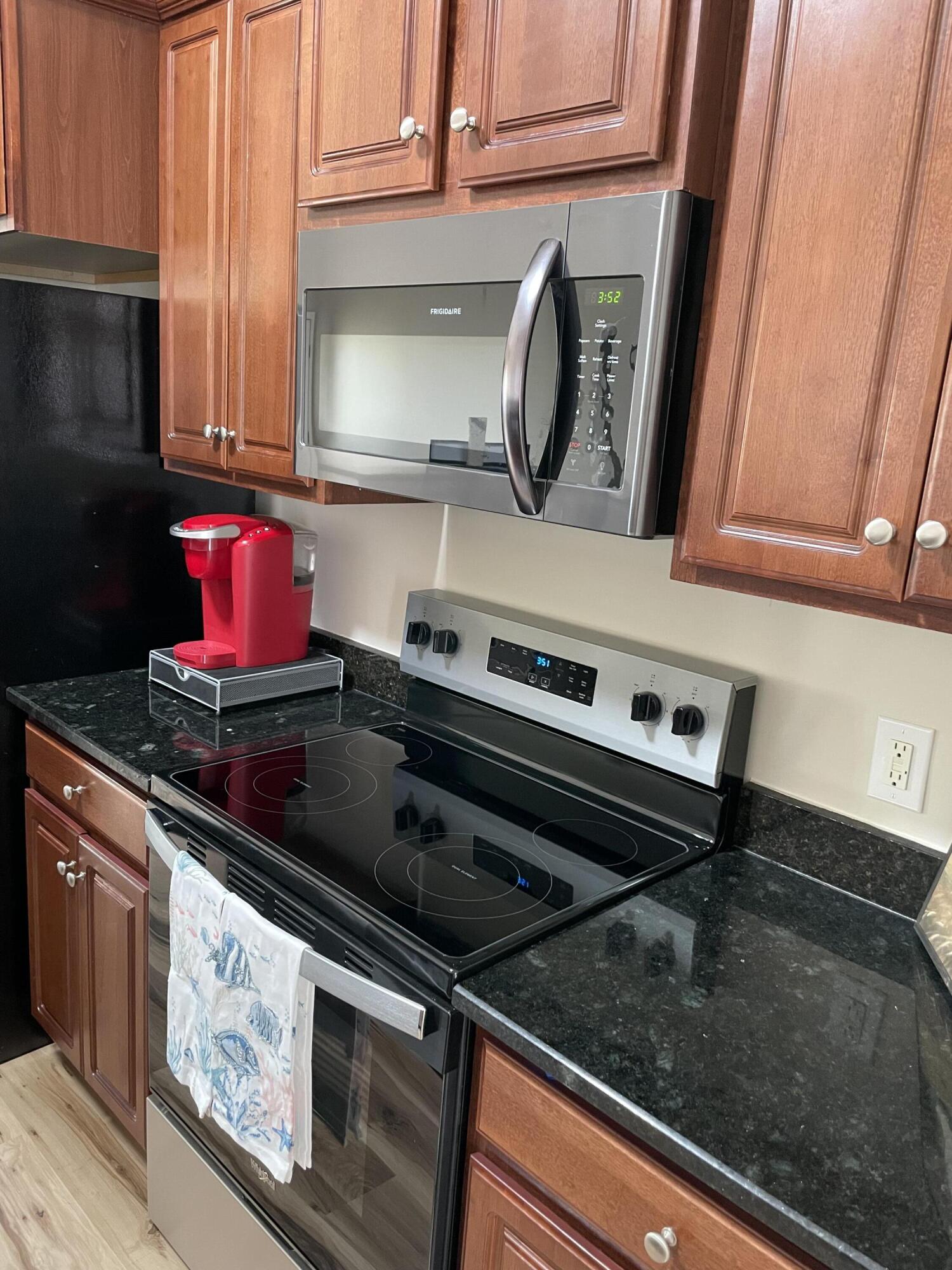 61 Mallot Beach Drive Freeport, FL 32439 - Photo 8 of 19 a kitchen with a stove microwave and cabinets