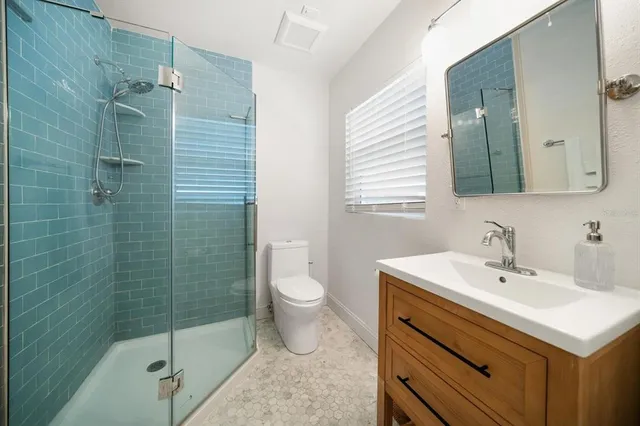 a bathroom with a sink toilet and shower