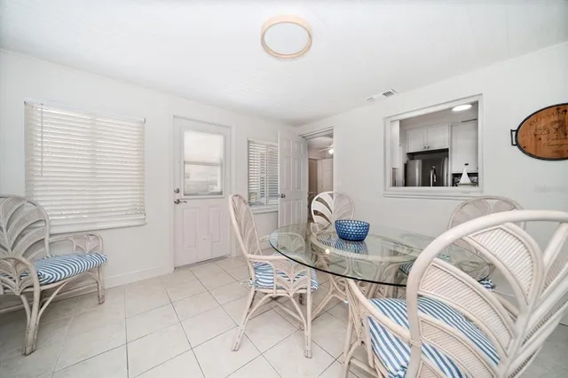a view of a dining room with furniture and a window
