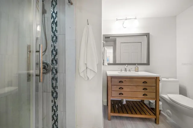 a bathroom with a sink vanity granite and a mirror