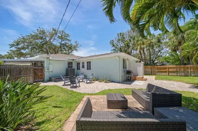 a view of a backyard with swimming pool