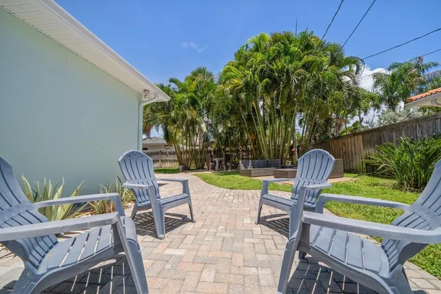 a view of a chairs and table in patio with wooden fence