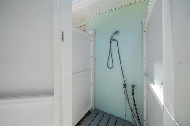 a bathroom with a glass shower door