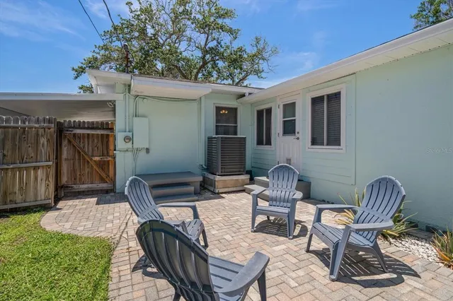 a view of a backyard with sitting area