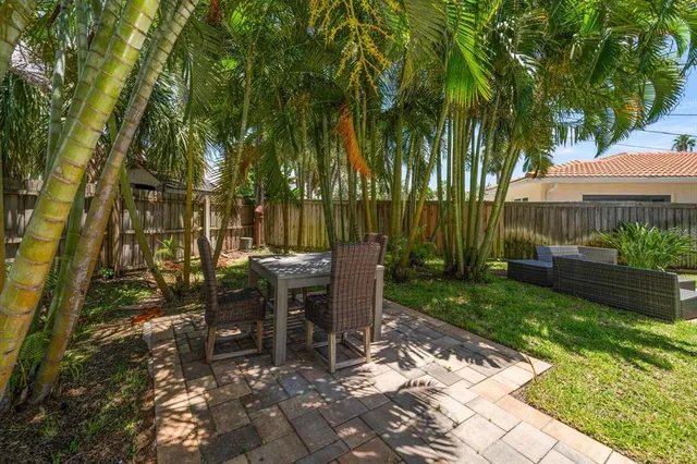a view of a house with a yard and sitting area