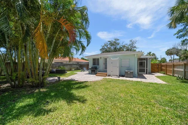 a view of a backyard with furniture and a yard