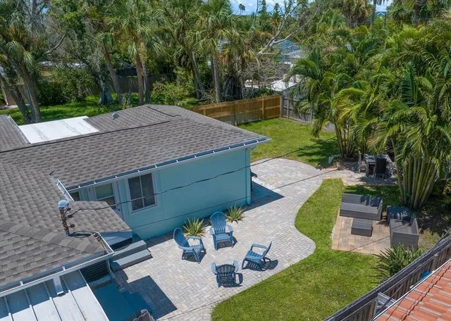 a front view of house with yard and trees around