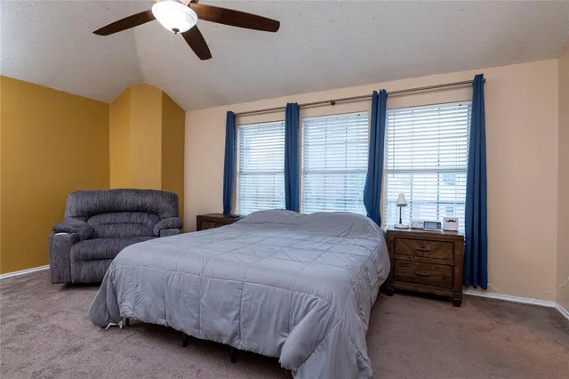 a bedroom with a bed dresser and a window