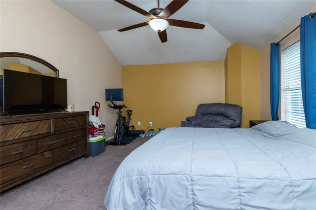 a bedroom with a bed and flat screen tv
