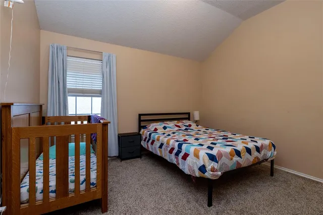 a bedroom with two beds and window