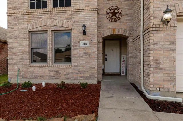 a front view of a house with a brick wall