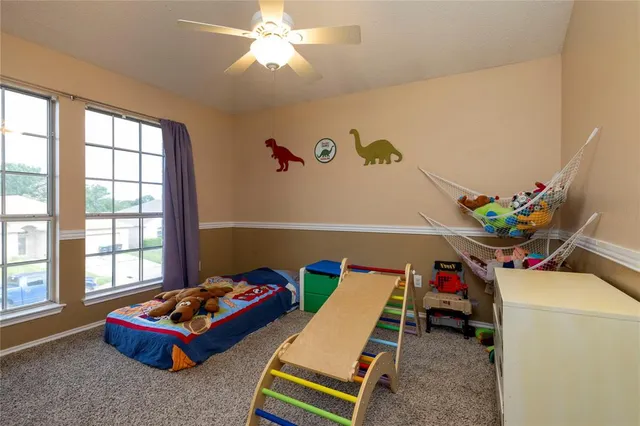 a living room with furniture toys and a window