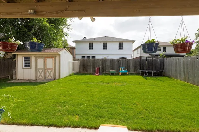 a view of a house with backyard and sitting area