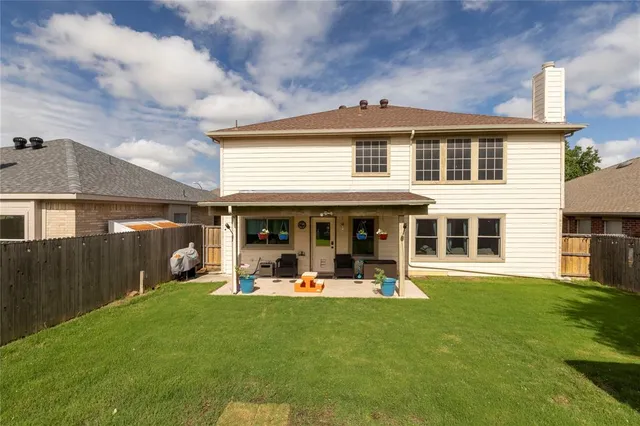 a backyard of a house with yard and outdoor seating