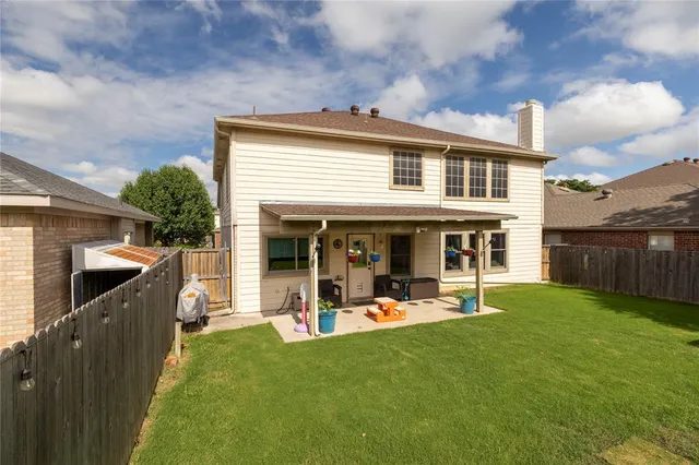 a view of a house with a yard and furniture