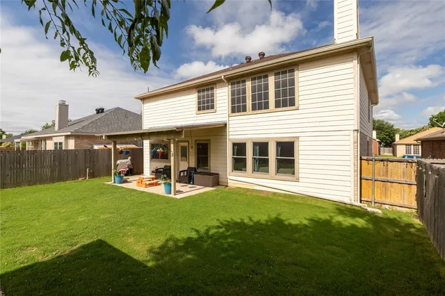 a view of a house with a yard and sitting area