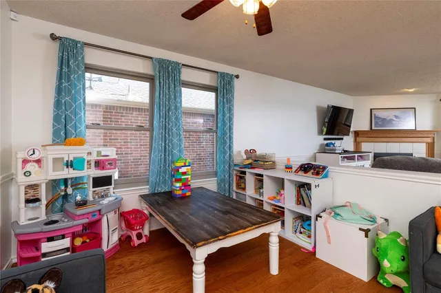 a living room with furniture a flat screen tv and a window