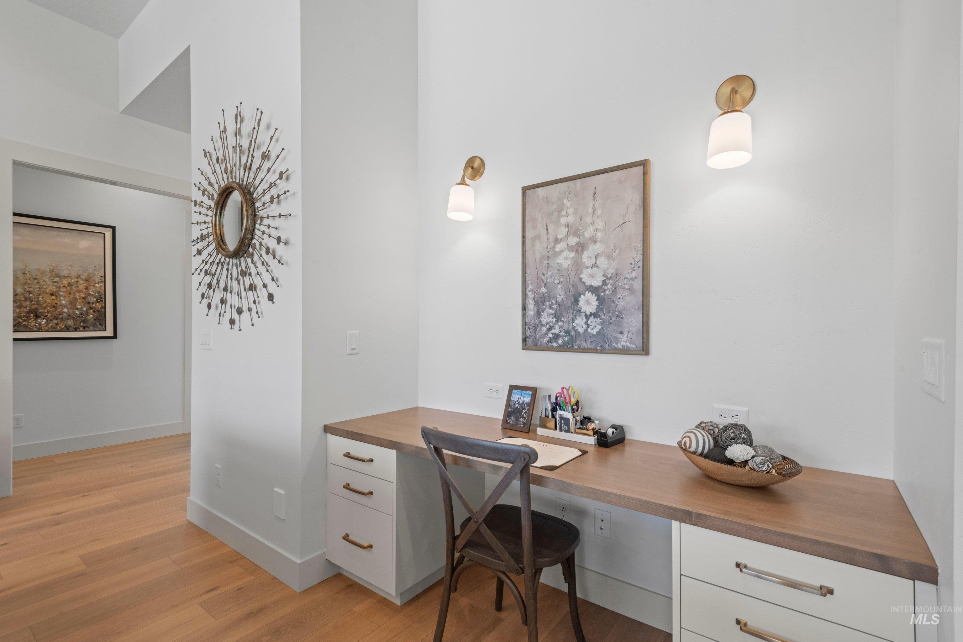 24990 Belgian Way Middleton, ID 83644 - Photo 35 of 50 Built-in desk featuring a wood-finish countertop and white cabinetry with brass hardware