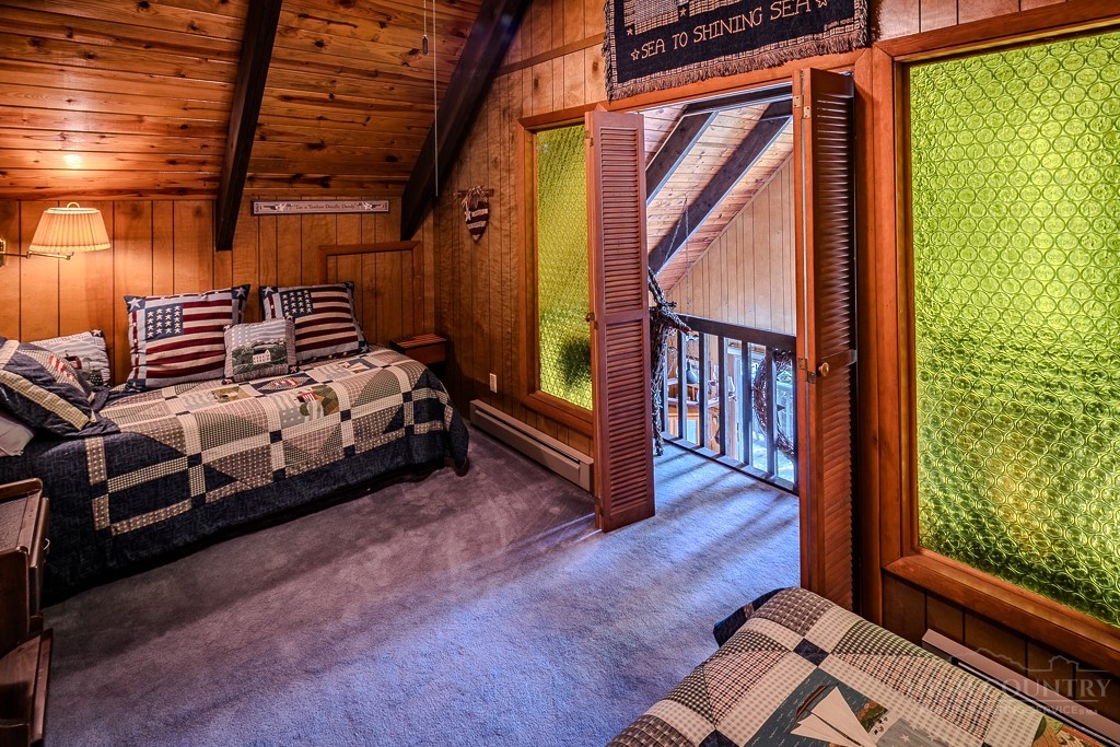 107-109 Shagbark Road Beech Mountain, NC 28604 - Photo 36 of 45 a bedroom with furniture and a window