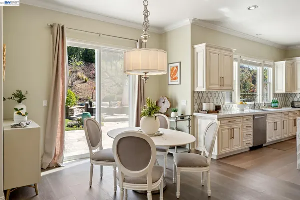 a large kitchen with kitchen island a large counter top space a sink a window and living room view