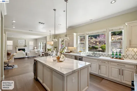 a large kitchen with kitchen island a large window in it